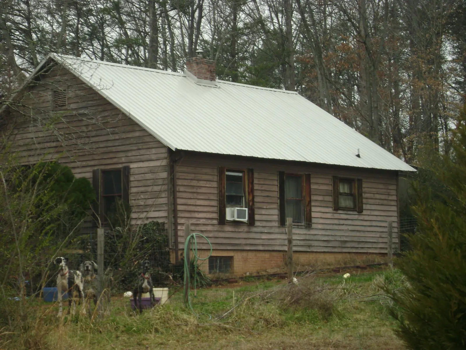 White metal roof on an old wood sided farmhouse, from a Metal Roof Installation job in Mont Clare